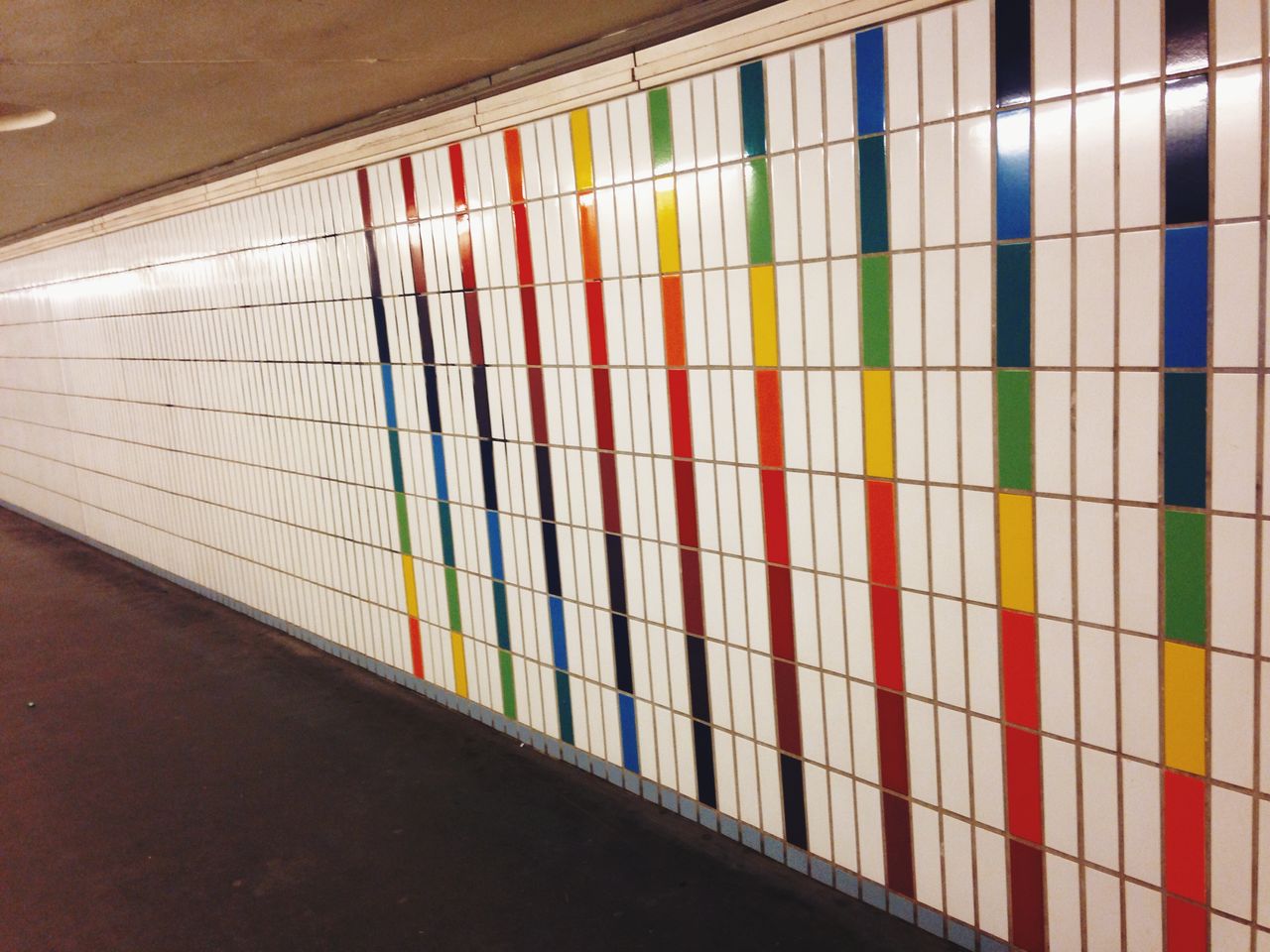 Multicolored lines on tiled wall