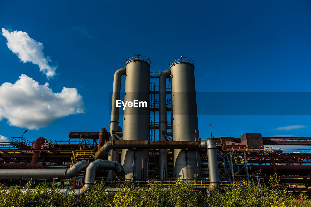 Low angle view of factory against sky