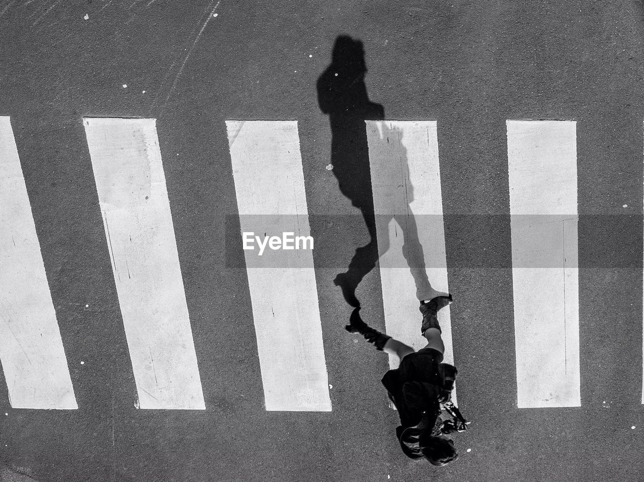 High angle view of woman on zebra crossing