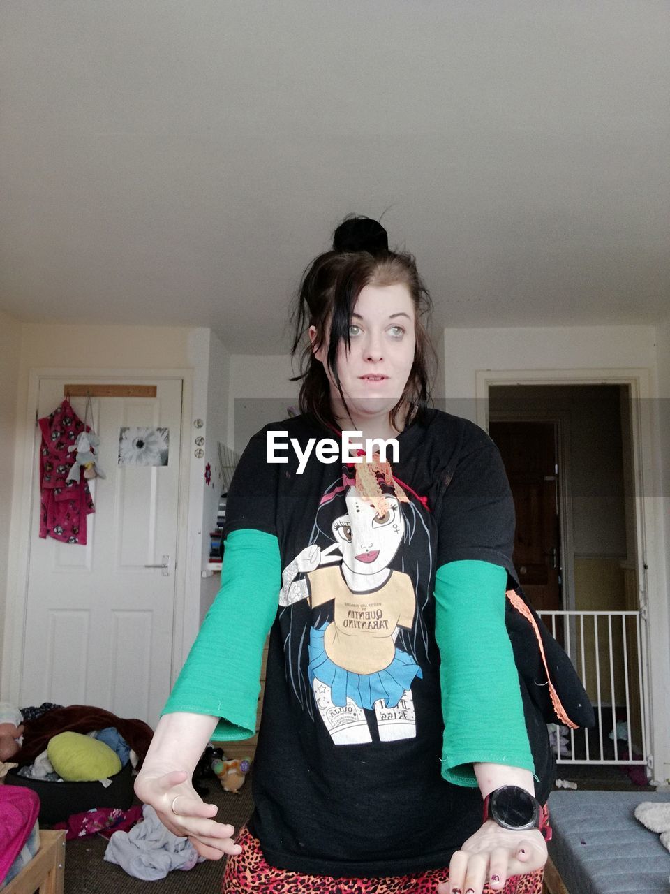 one person, indoors, women, clothing, front view, adult, domestic life, lifestyles, looking at camera, home interior, portrait, child, domestic room, female, person, standing, emotion, childhood, birthday cake, holding, young adult, sitting, three quarter length, costume, party, hairstyle, house, brown hair, waist up, casual clothing