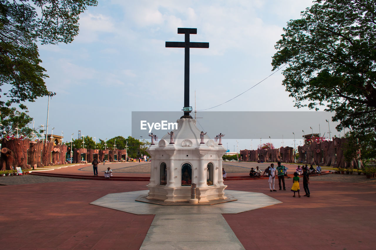 Low angle view of cross against sky