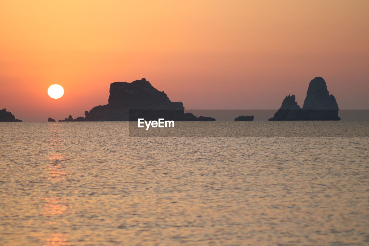 SCENIC VIEW OF SEA AGAINST ORANGE SKY DURING SUNSET