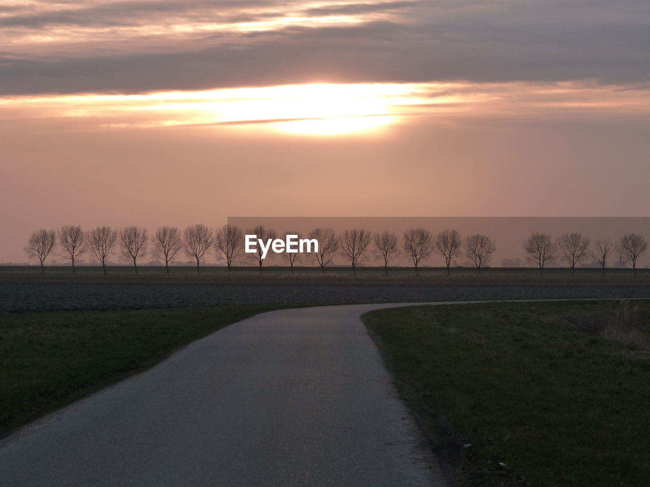 Scenic view of field against sky during sunset