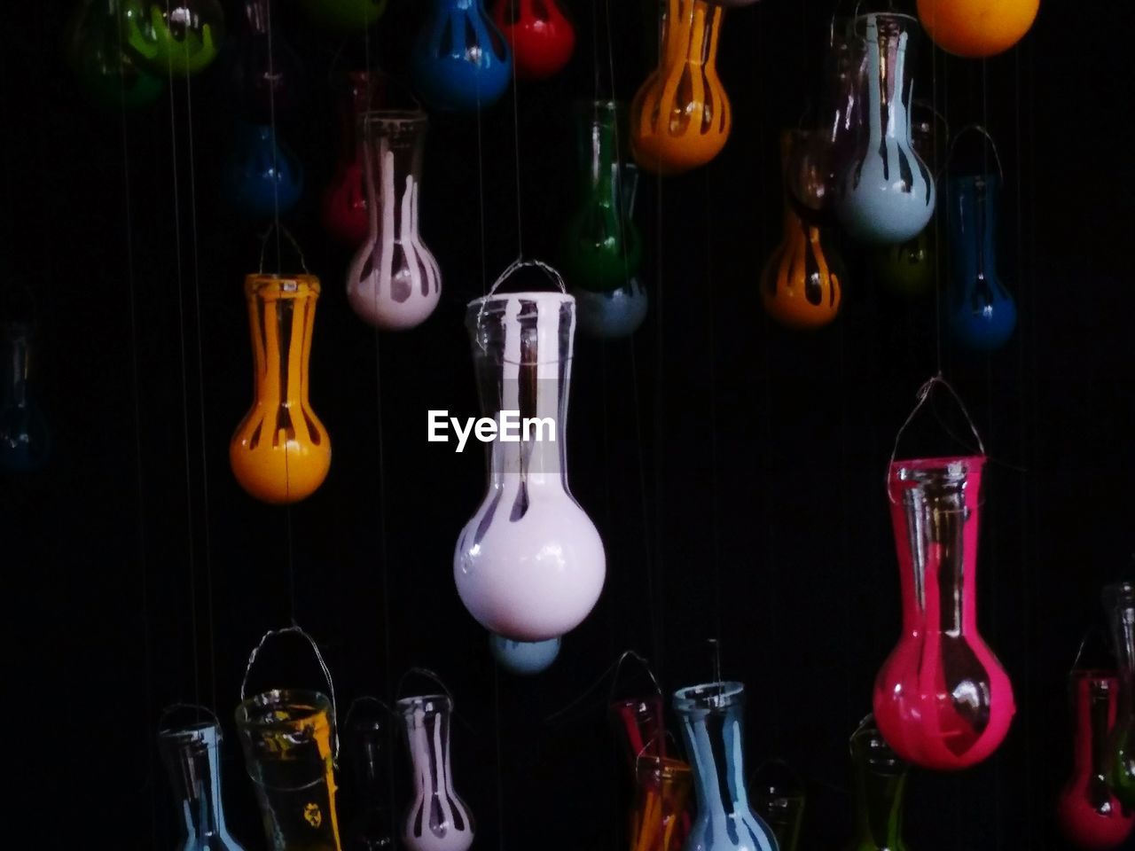 CLOSE-UP OF BOTTLES HANGING IN KITCHEN