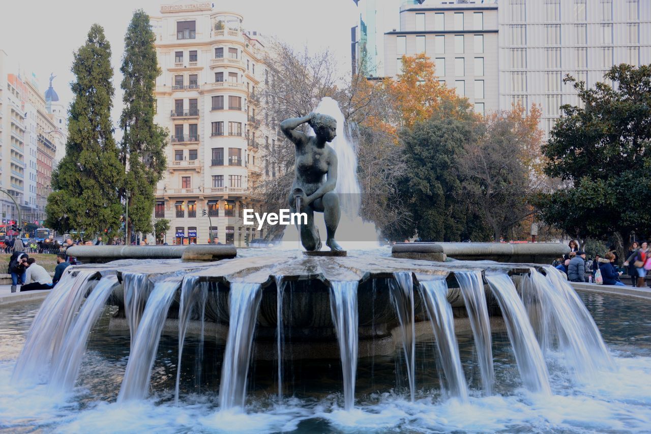 VIEW OF FOUNTAIN AGAINST BUILDINGS