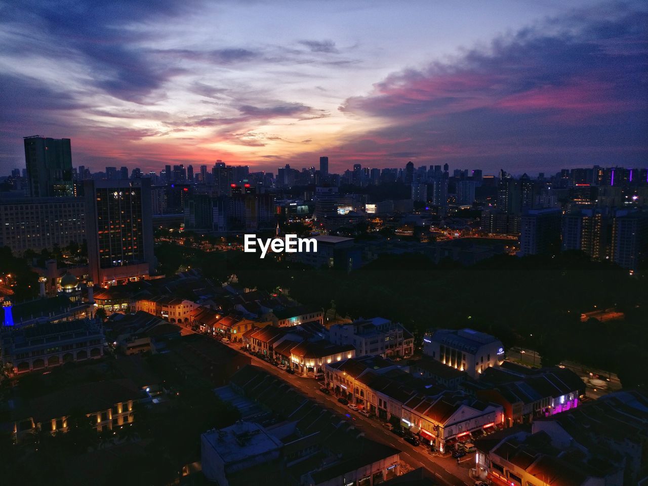 High angle view of city lit up at night