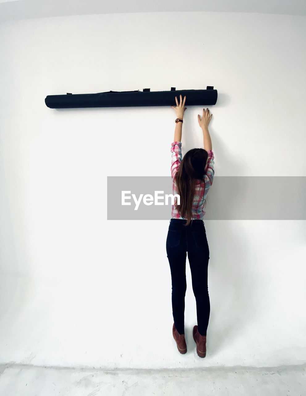 FULL LENGTH OF WOMAN STANDING ON WALL