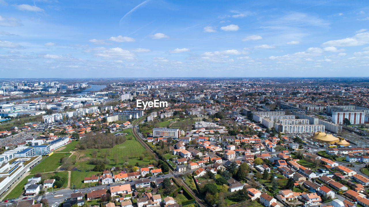 High angle view of townscape by sea against sky