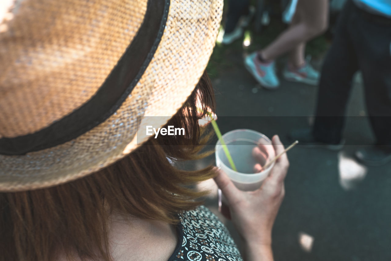 Rear view of woman drinking punch at street festival