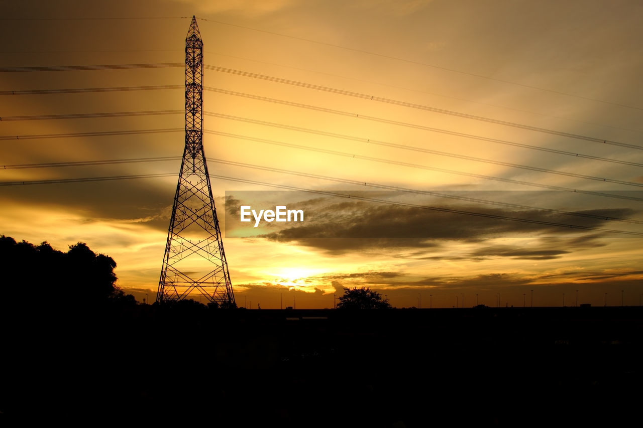 SILHOUETTE ELECTRICITY PYLONS AGAINST SKY DURING SUNSET