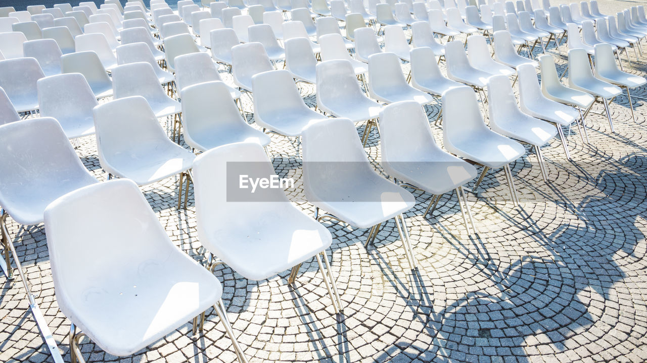 Full frame shot of empty chairs arranged outdoors