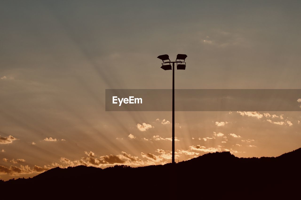 low angle view of street light against clear sky during sunset