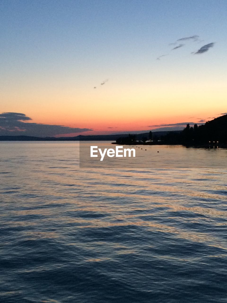 Scenic view of lake balaton against sunset sky