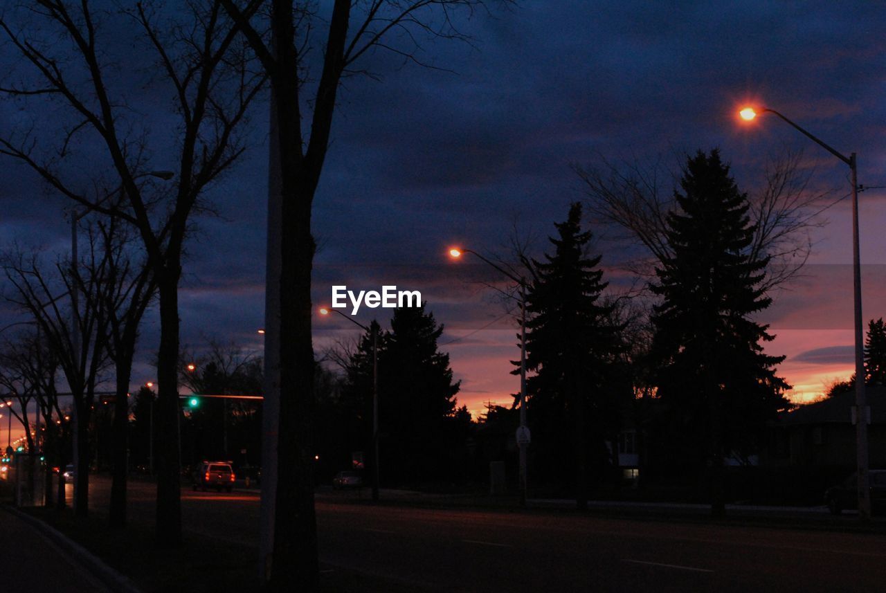 VIEW OF ILLUMINATED STREET LIGHTS AT NIGHT