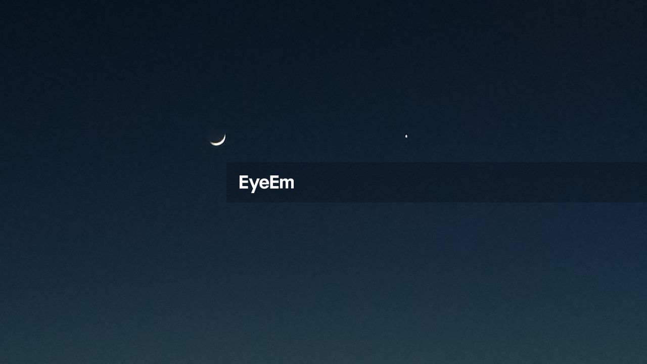LOW ANGLE VIEW OF MOON IN SKY