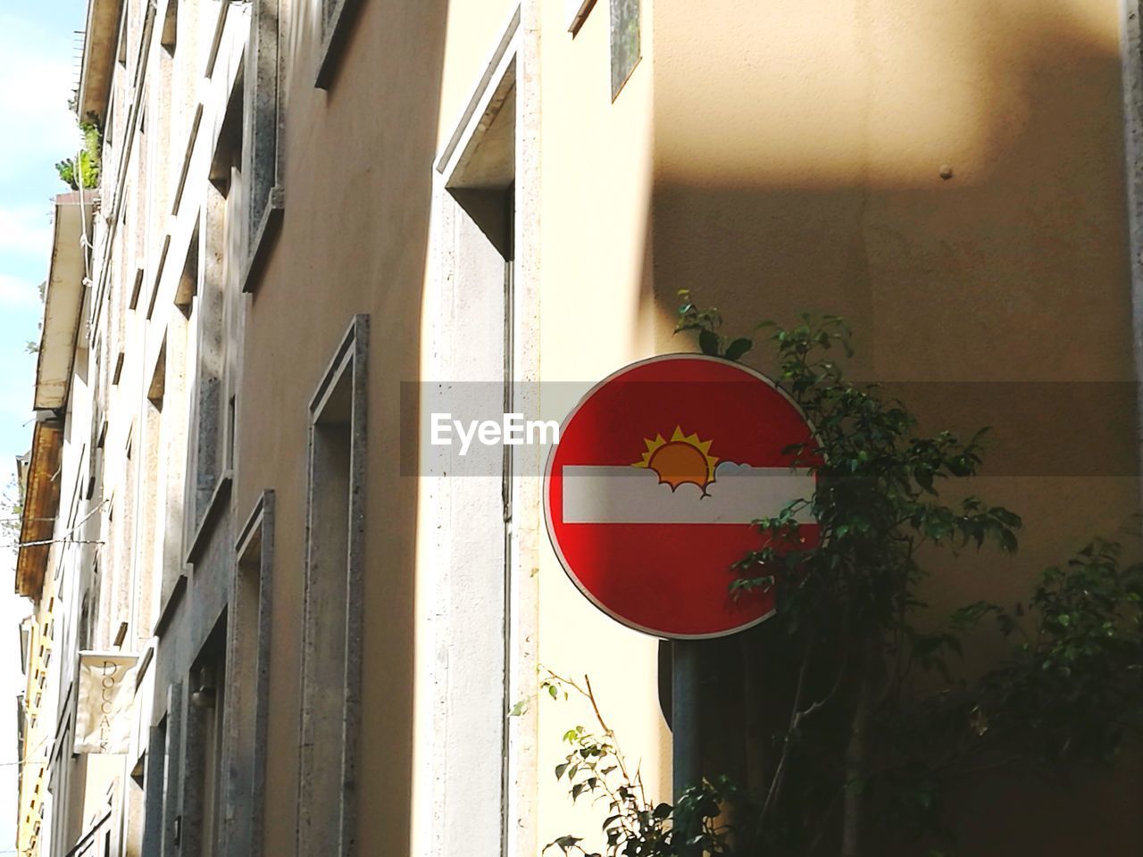 Close-up of road sign against built structure