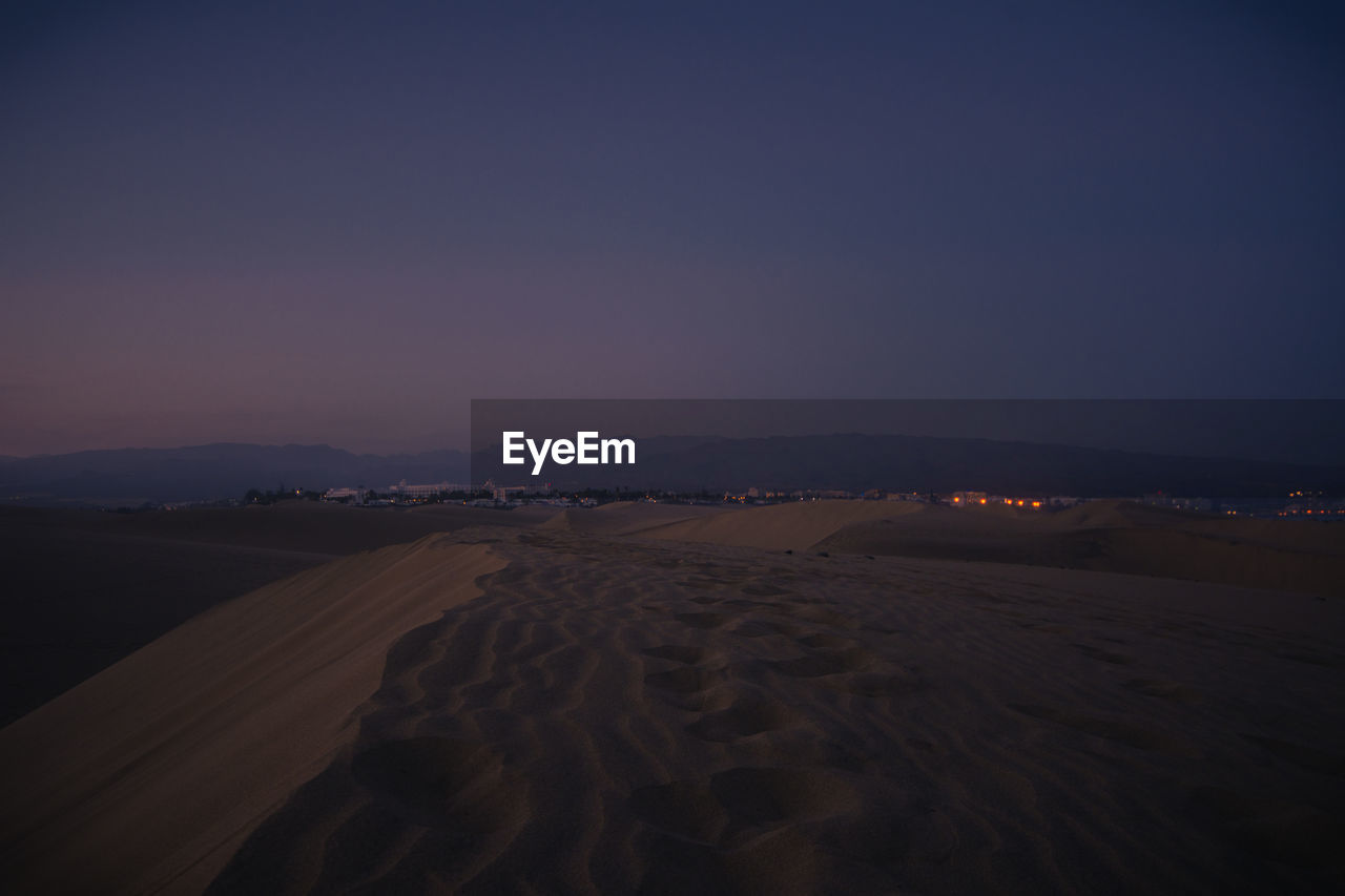 Scenic view of desert against sky at night