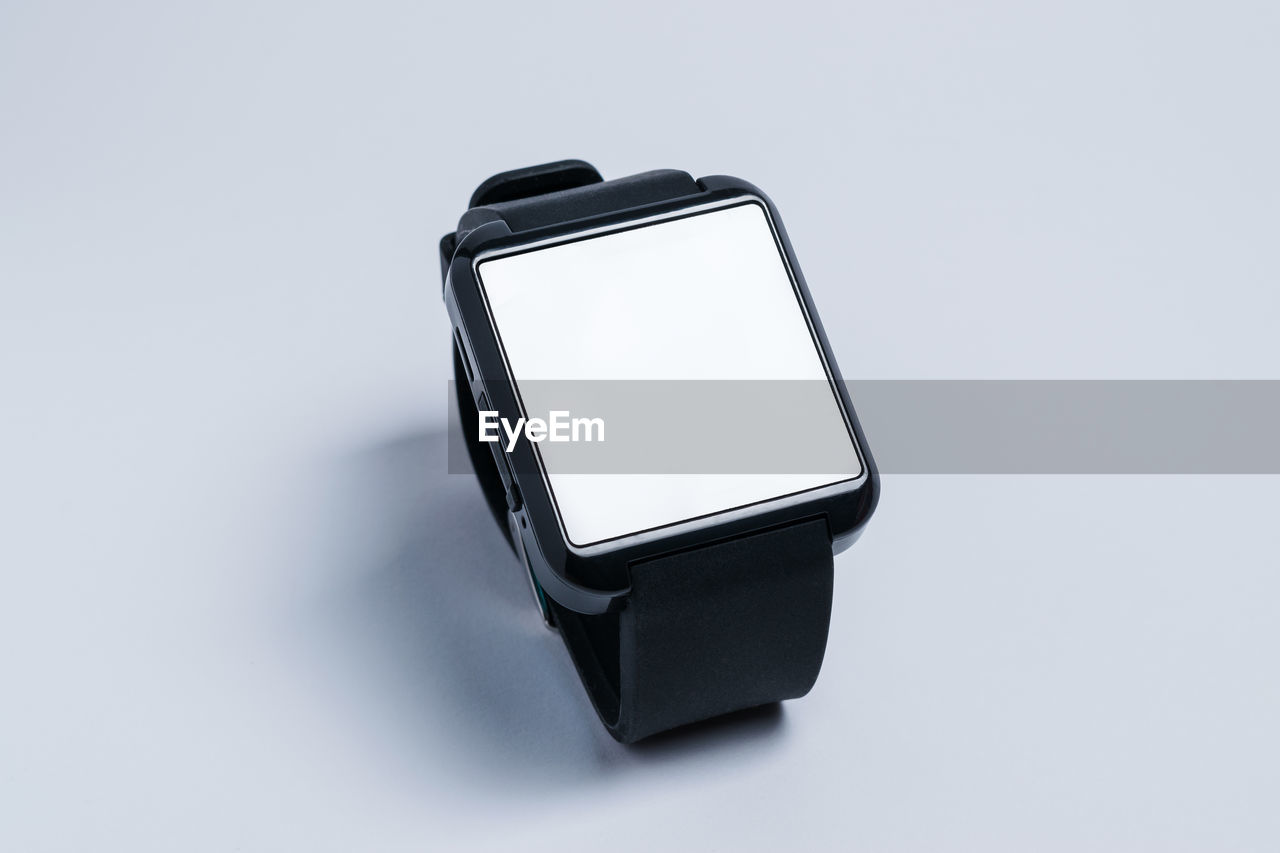 Close-up of smartwatch against white background