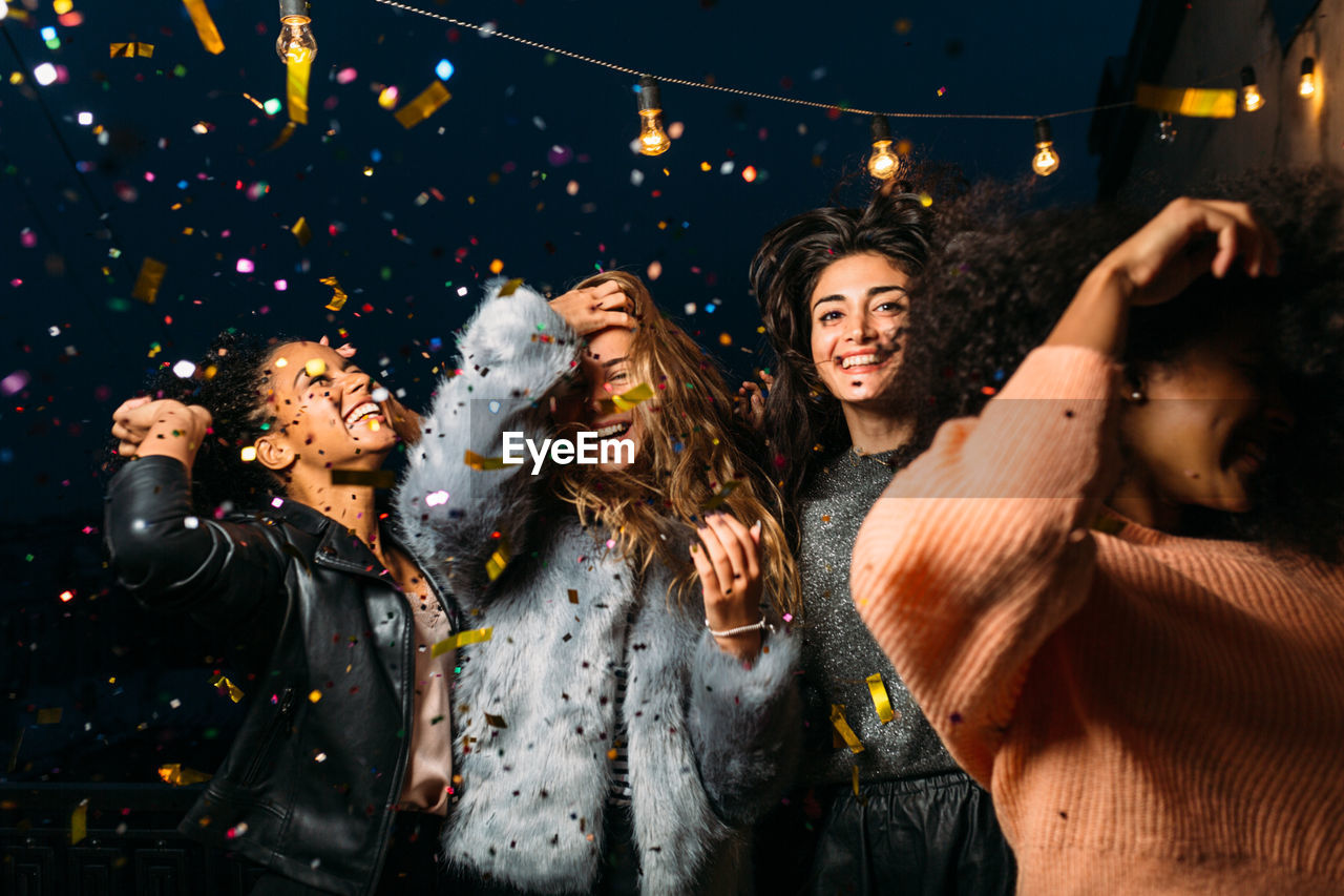 Young female friends enjoying party at night