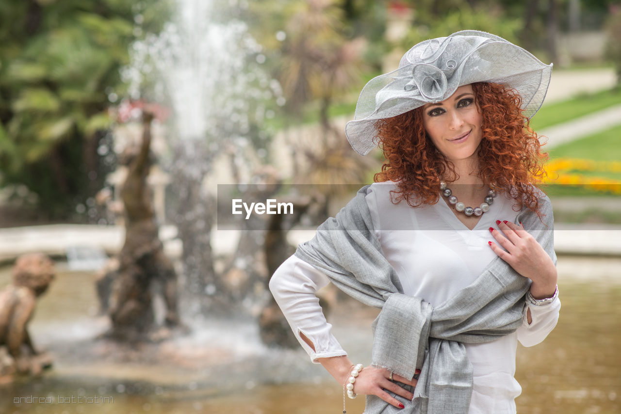 Portrait of smiling young woman standing outdoors