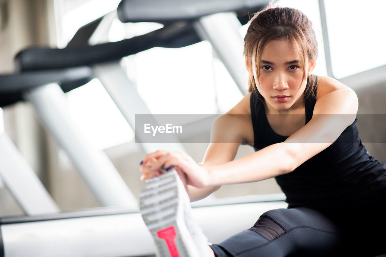 Young woman exercising in gym