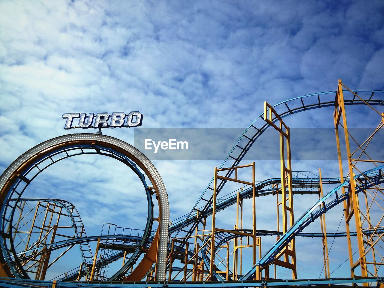 LOW ANGLE VIEW OF AMUSEMENT PARK AGAINST SKY