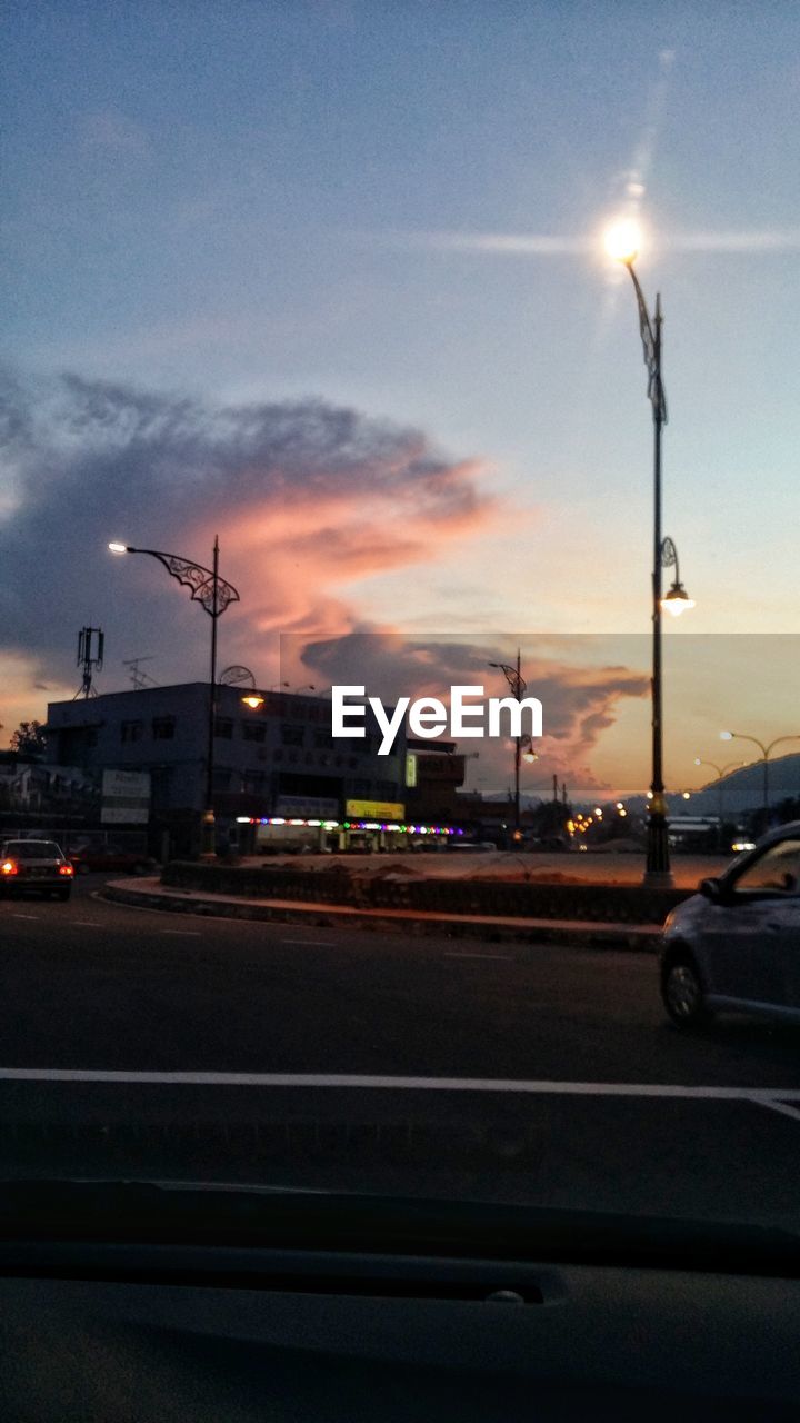 CARS ON ROAD AT SUNSET