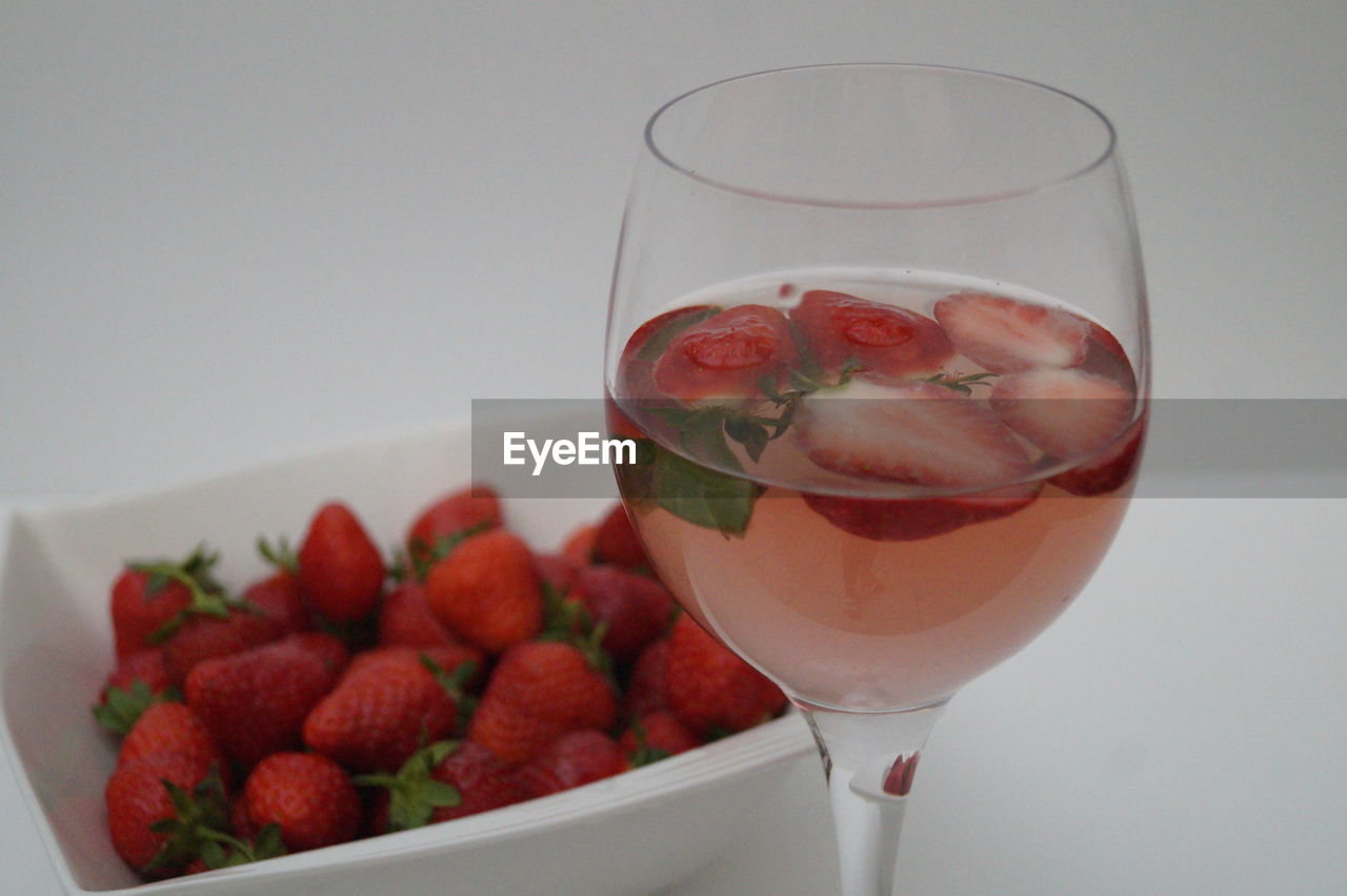 CLOSE-UP OF FRUITS IN GLASS WITH DRINK