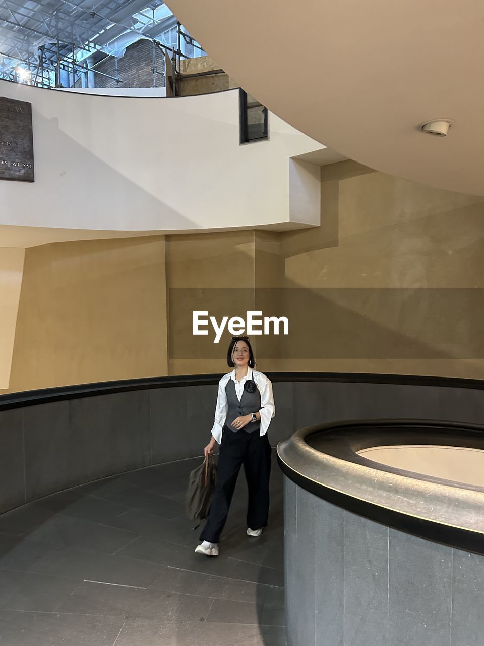 indoors, room, one person, ceiling, architecture, lifestyles, interior design, floor, adult, high angle view, staircase, technology