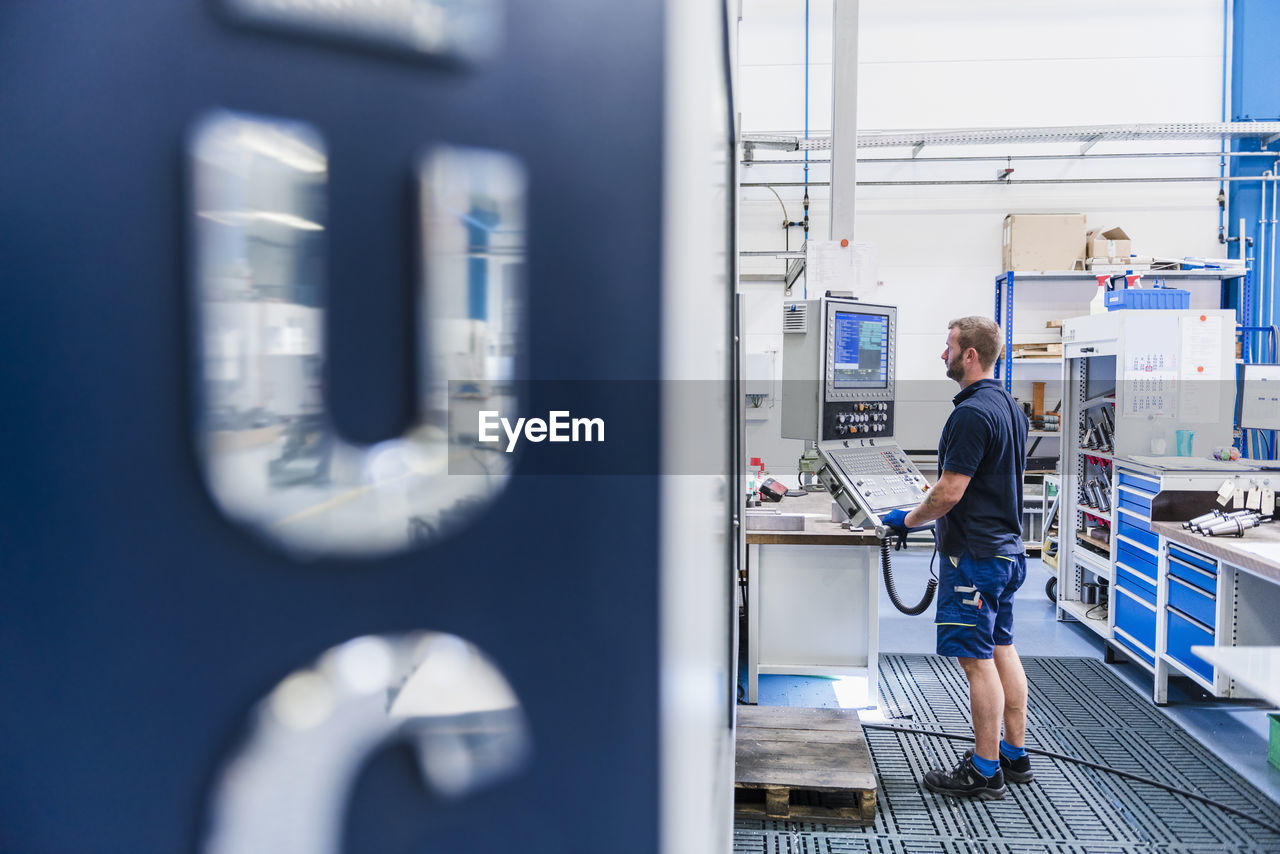 Man operating machine in industrial factory