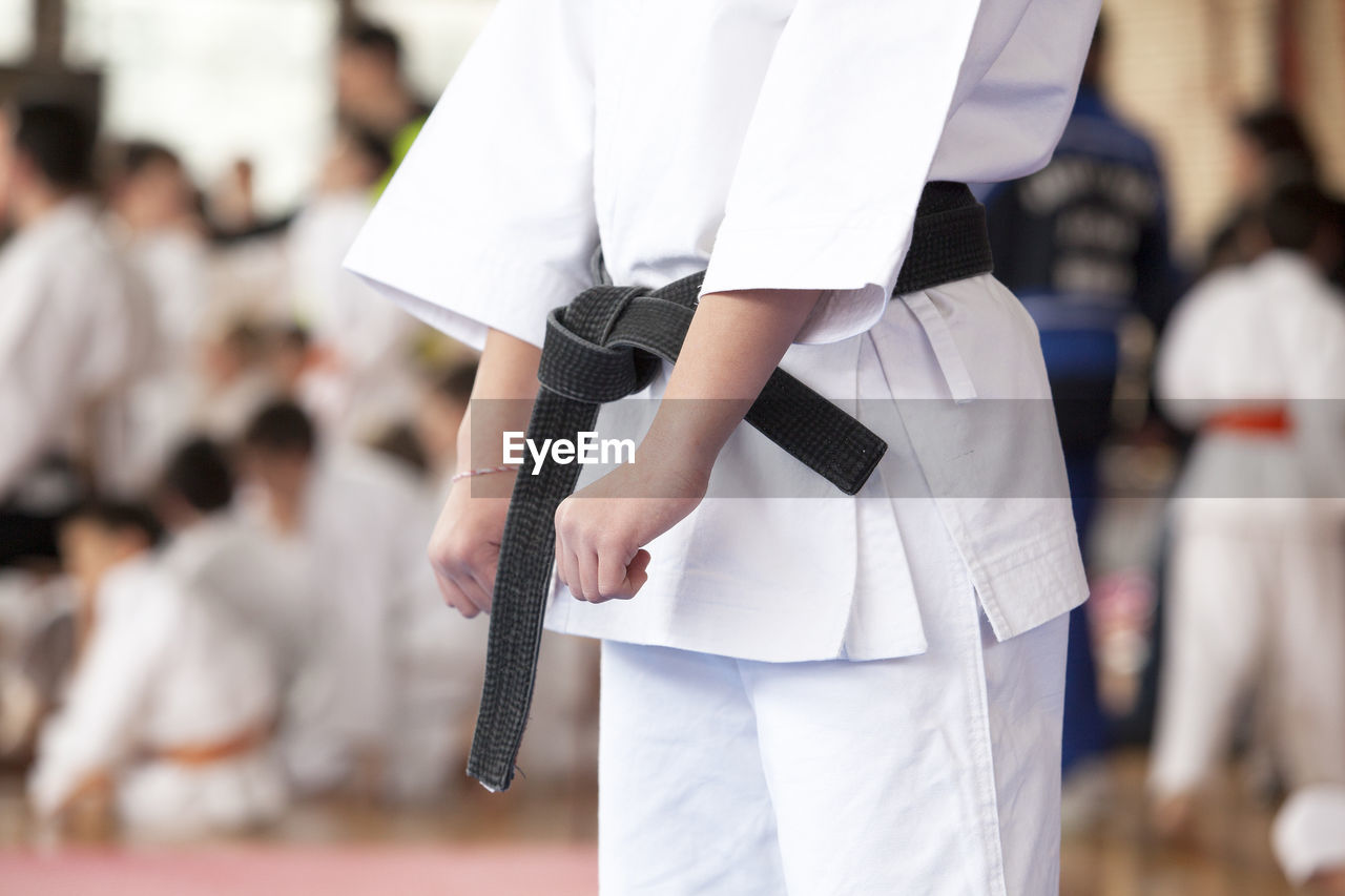 Midsection of women practicing karate