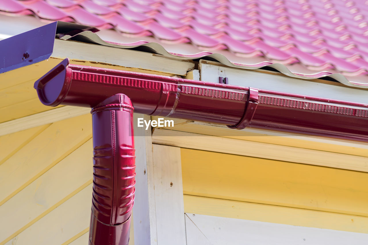 Red gutter on the roof top of house