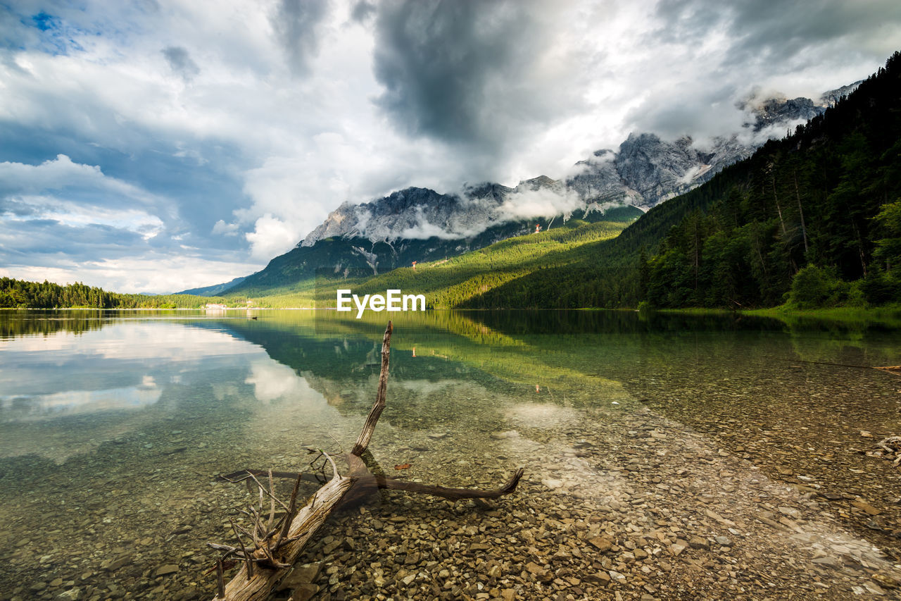 Scenic view of lake and mountains against sky