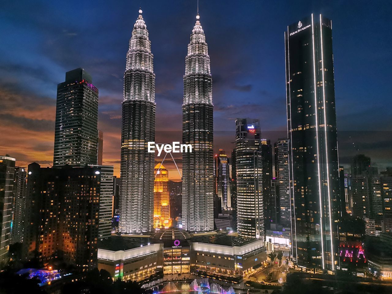 architecture, city, building exterior, built structure, office building exterior, skyscraper, landscape, building, metropolitan area, cityscape, metropolis, skyline, urban skyline, illuminated, sky, travel destinations, night, landmark, downtown district, residential district, office, nature, city life, tower, travel, urban area, downtown, tower block, dusk, evening, no people, water, street, business finance and industry, transportation, tourism, business, outdoors, financial district, sunset, horizon, development, city street, cloud