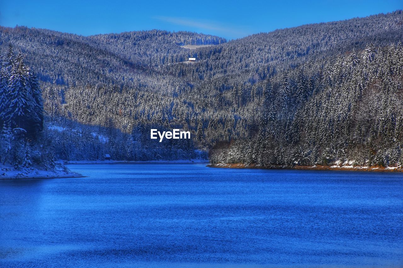 SCENIC VIEW OF FROZEN LAKE AGAINST MOUNTAINS