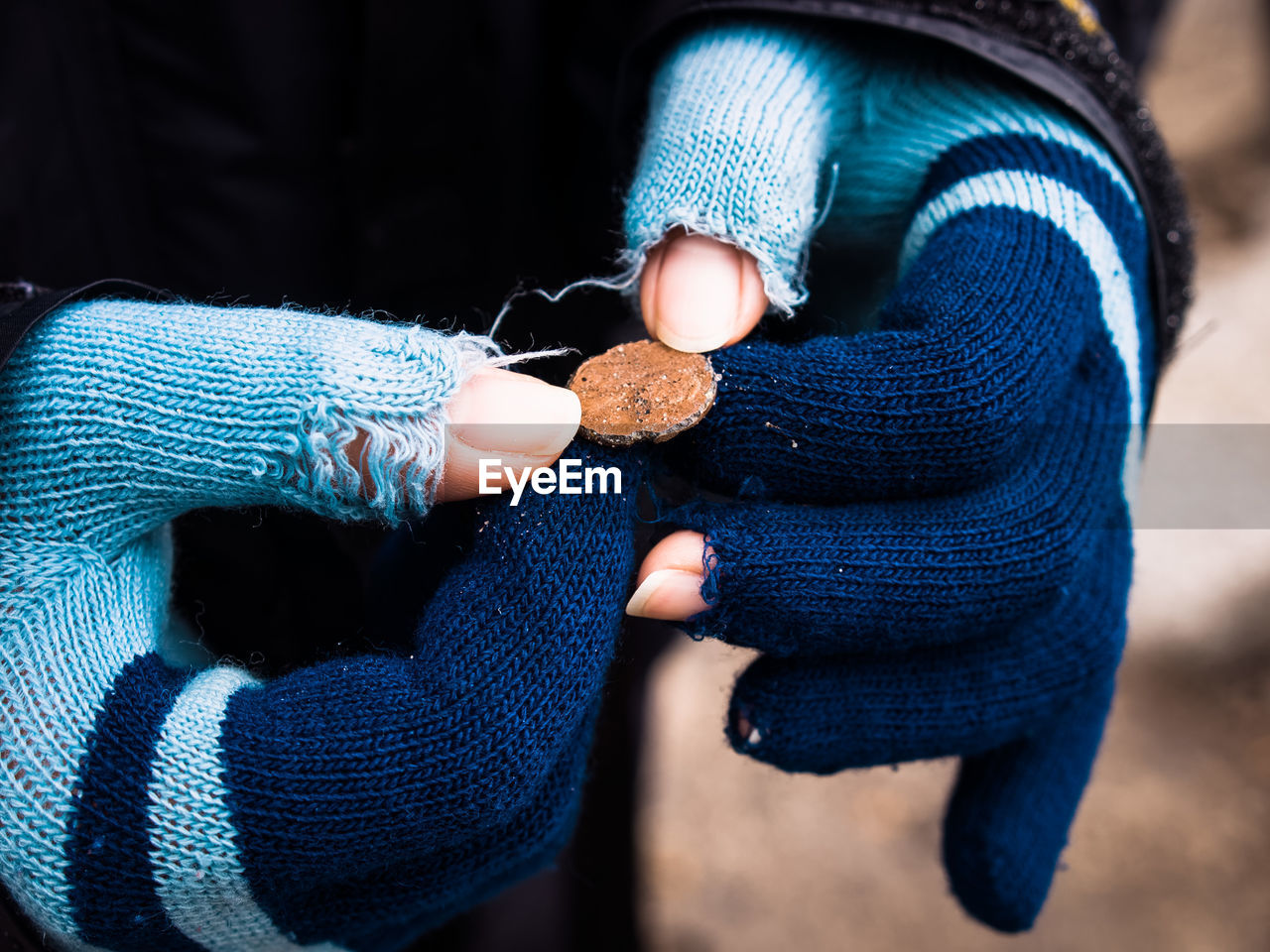 Midsection of woman holding penny