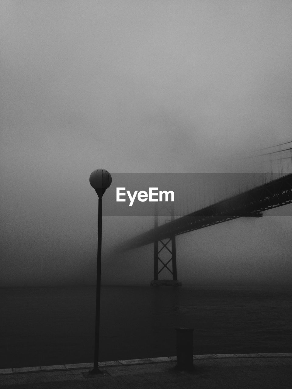 April 25th bridge on tagus river during foggy weather