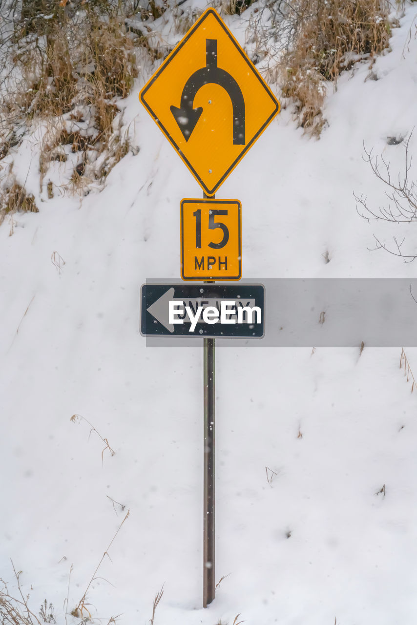 INFORMATION SIGN ON SNOW COVERED ROAD
