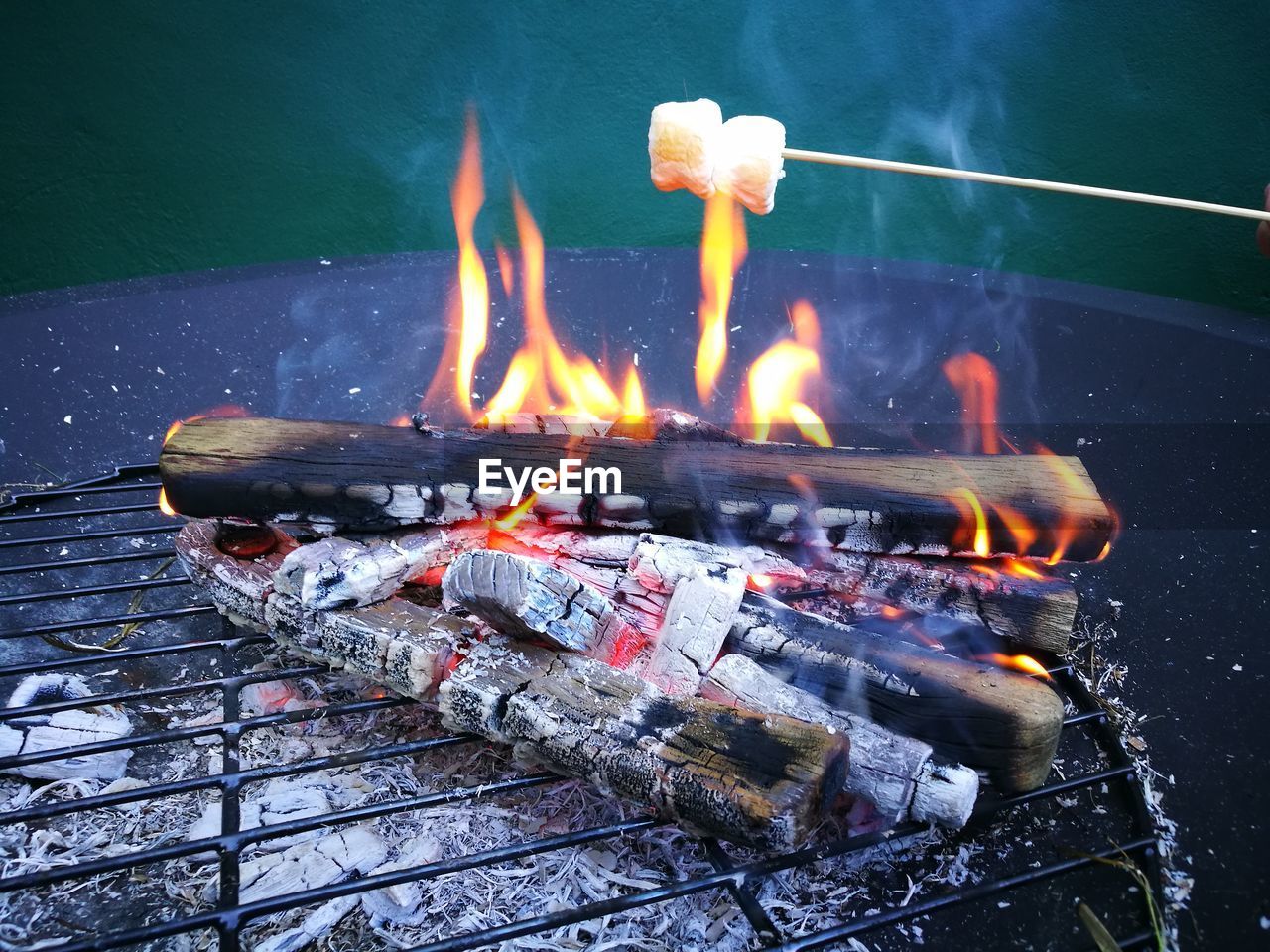 Marshmallows being roasted on barbecue grill