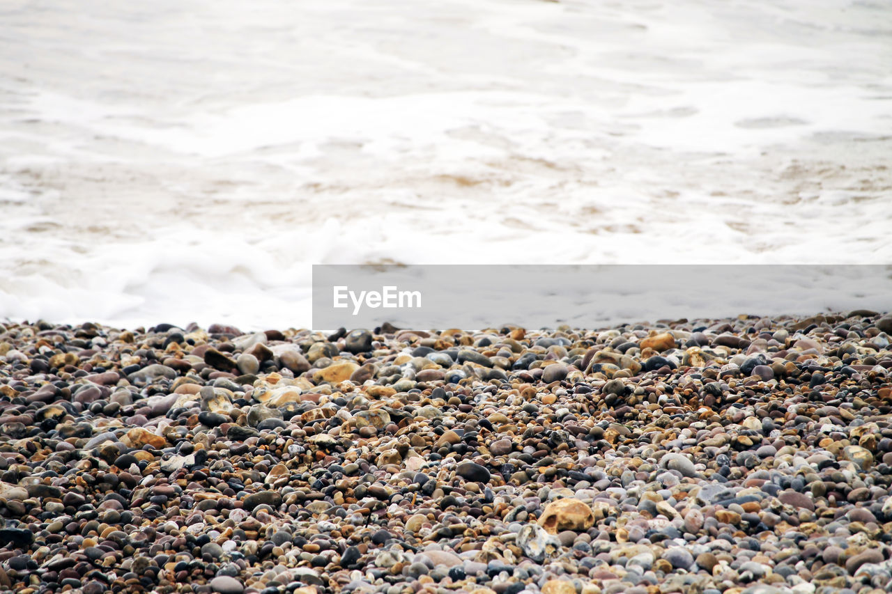 VIEW OF PEBBLES ON BEACH
