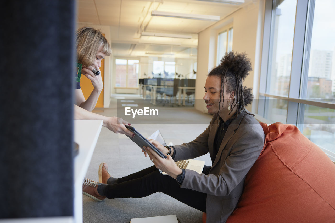 Man and woman talking in office