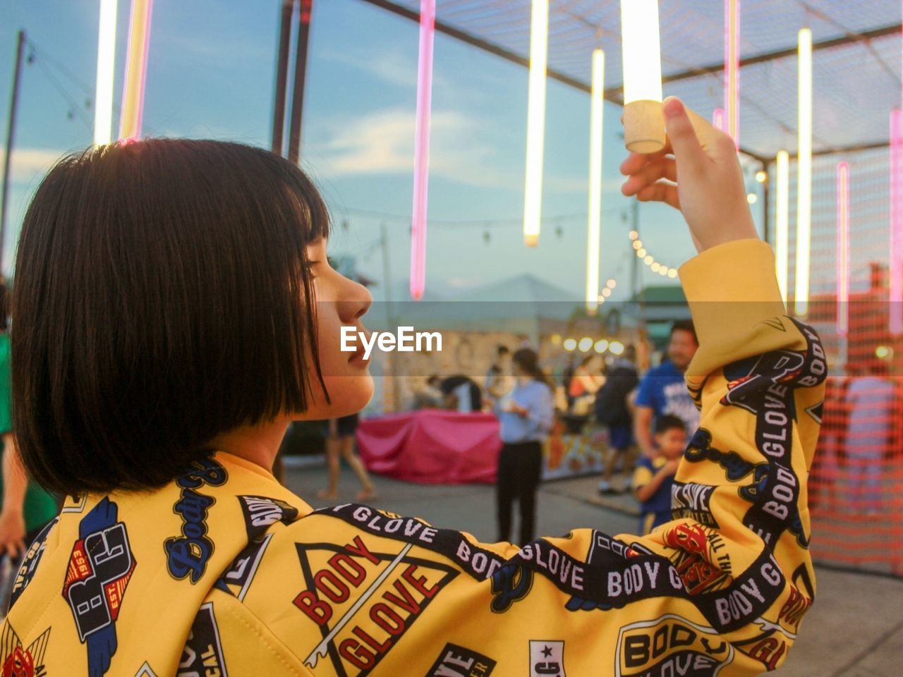 PORTRAIT OF A GIRL HOLDING CAROUSEL