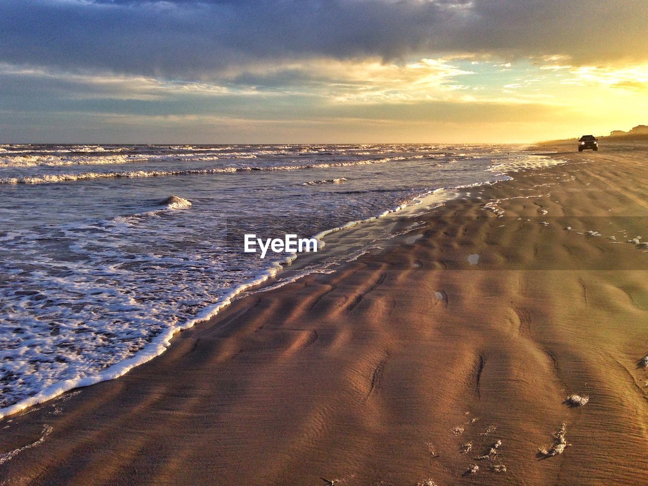 Scenic view of shore and sea against sky during sunset