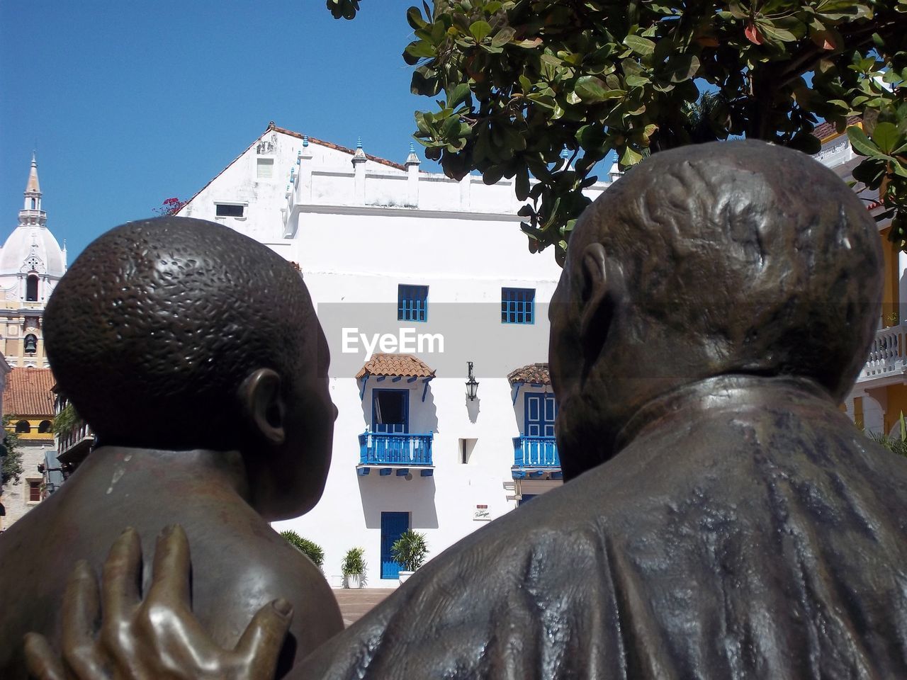 STATUE AGAINST BUILDING AND SKY