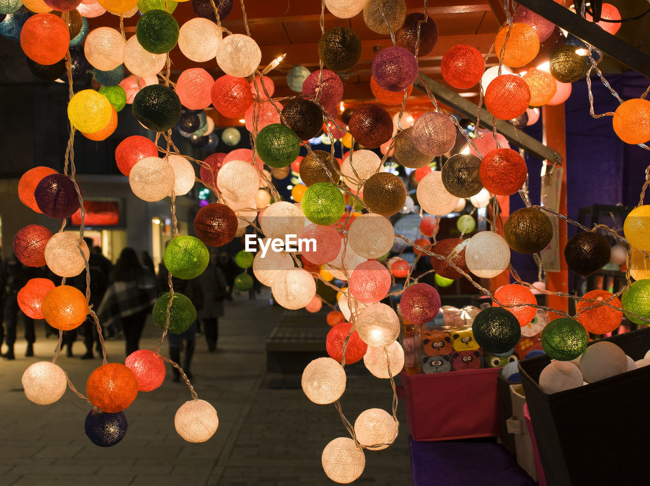 CLOSE-UP OF ILLUMINATED LANTERNS HANGING ON WALL