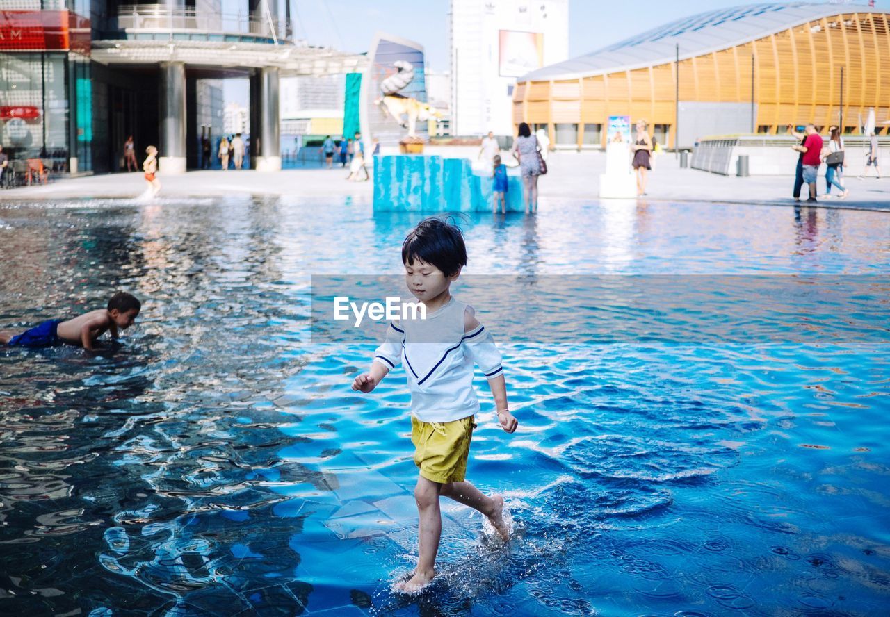 BOY IN SWIMMING POOL