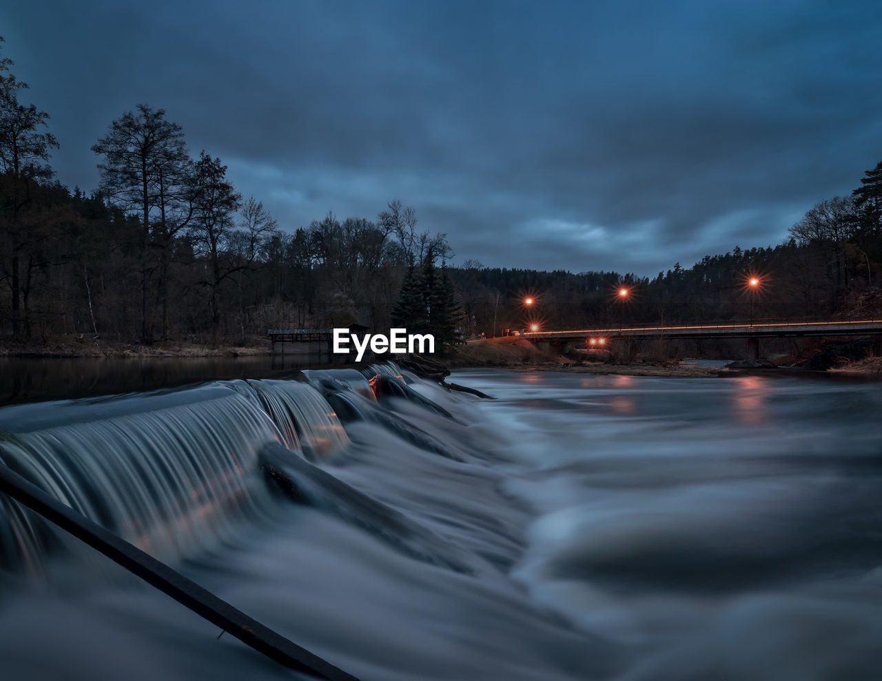 SCENIC VIEW OF WATERFALL AGAINST SKY DURING WINTER