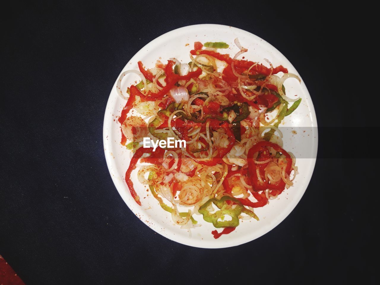 High angle view of pasta served in plate on black background