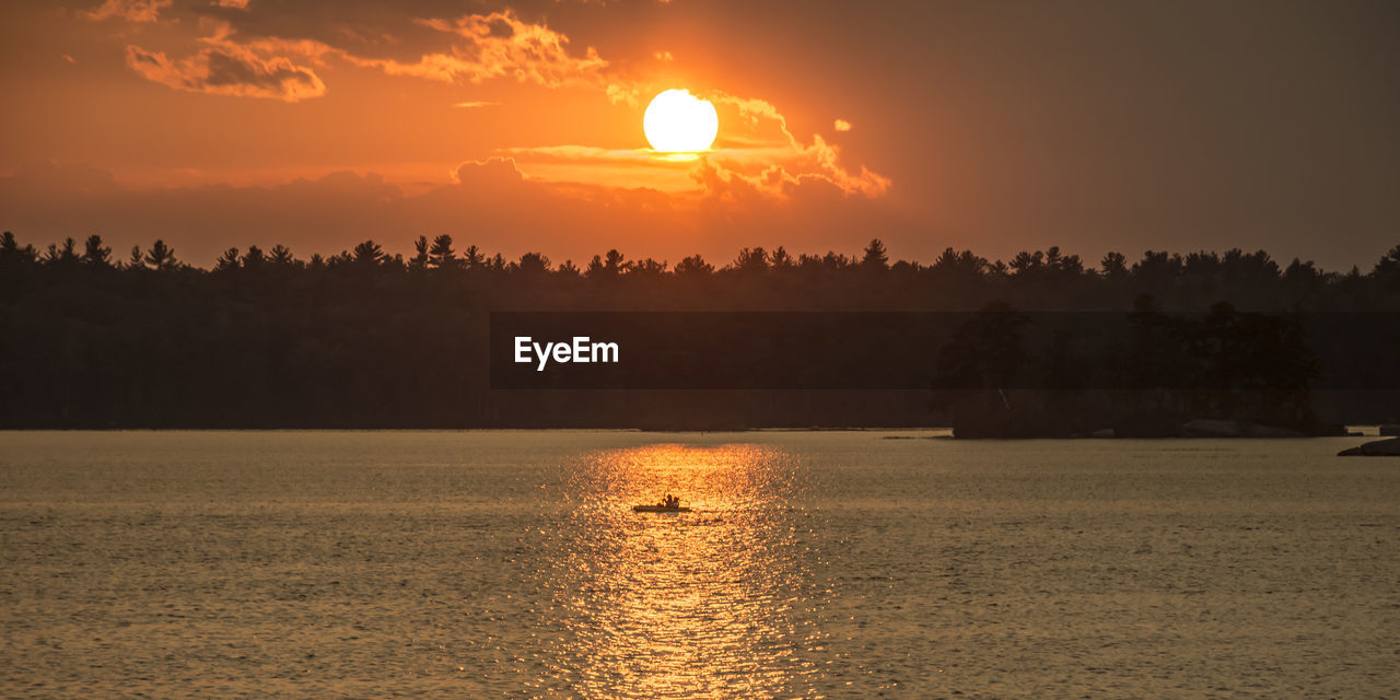 Scenic view of lake against sky during sunset