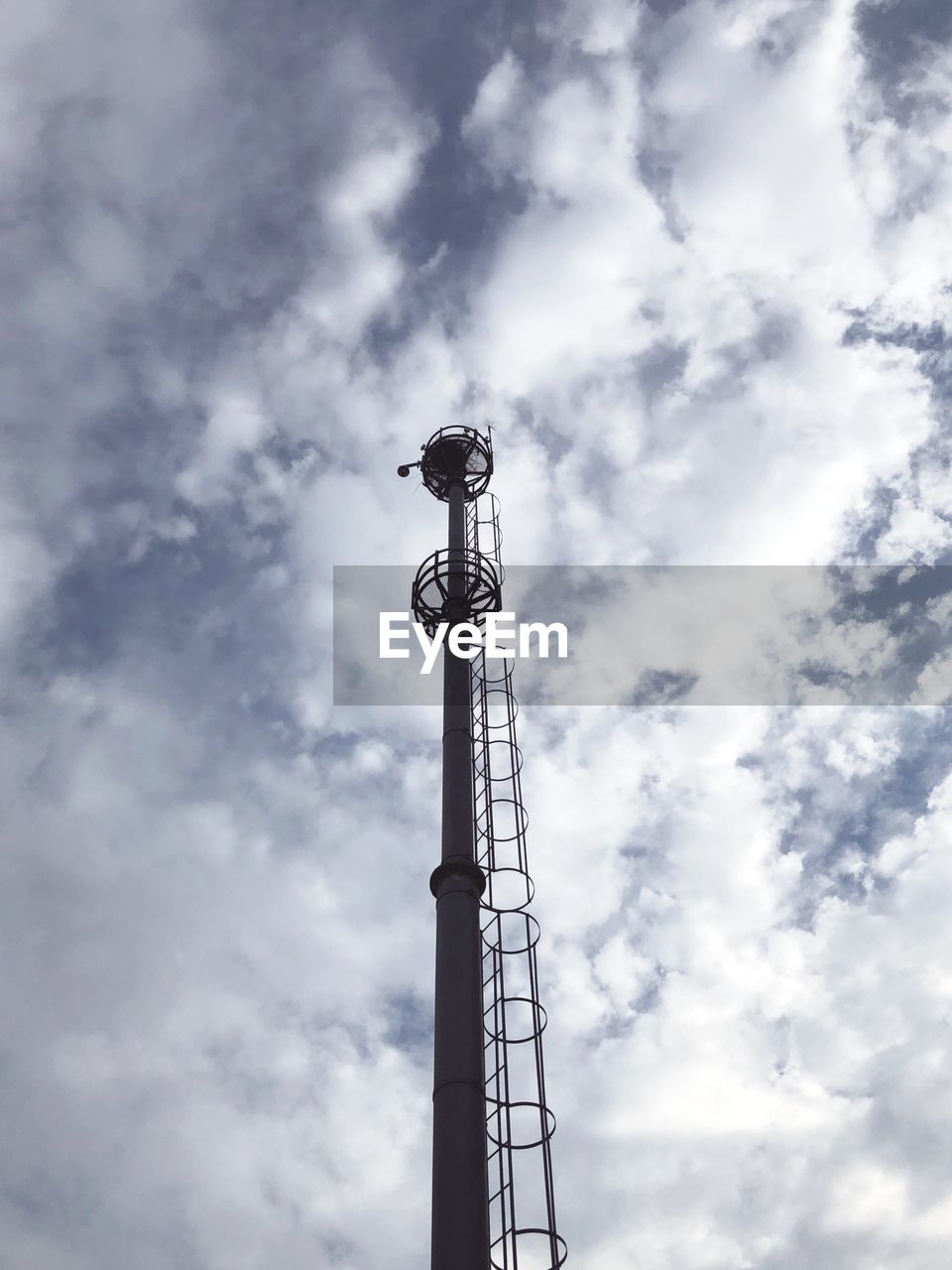 Low angle view of communications tower against sky